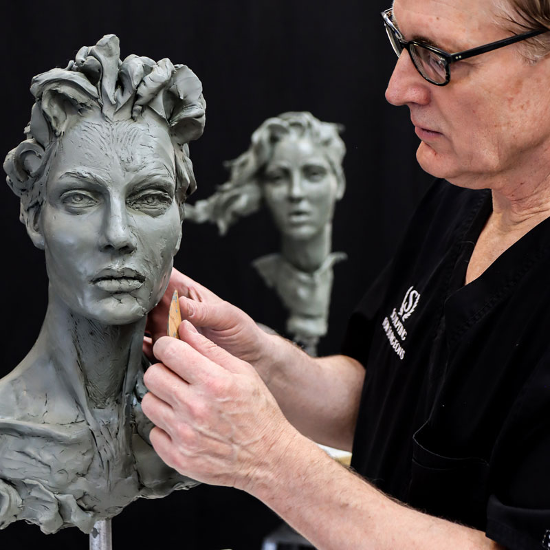 Dr. Schmid sculpting clay face